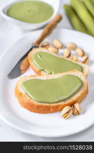 Slices of baguette with pistachio butter