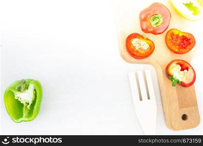 Slices of bell peppers on wooden board. Salad cooking, vegetarian menu, healthy food