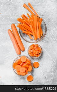 Slices of carrots in a glass bowl. On rustic background. Slices of carrots in a glass bowl.