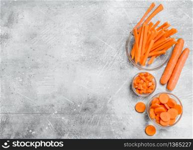 Slices of carrots in a glass bowl. On rustic background. Slices of carrots in a glass bowl.