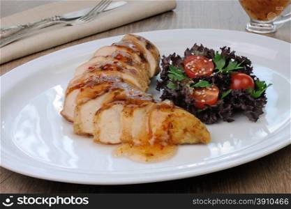 Slices of chicken fillet with sweet and sour sauce