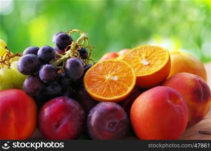 slices of citric fruit, peaches, grapes and plums
