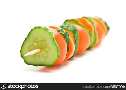 slices of cucumbers and tomatoes on a wooden stick isolated on white background