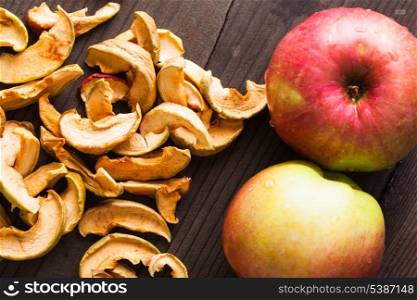 Slices of dried apples on the wooden table closeup
