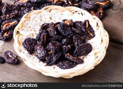 Slices of dried plums closeup on a plate
