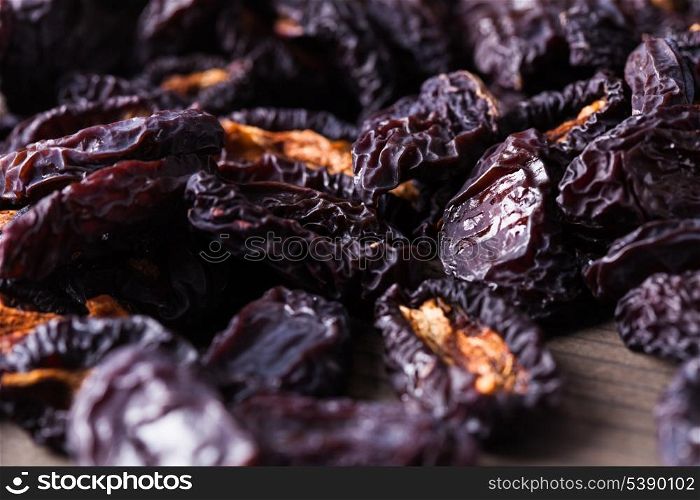 Slices of dried plums closeup on a table