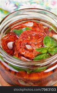 Slices of dried tomatoes with garlic and basil oil