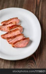 Slices of duck breast on the white plate