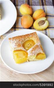 Slices of fresh apricot iced sponge cake with fruits