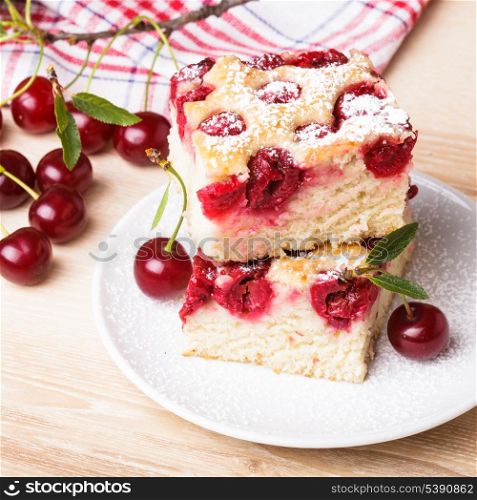 Slices of fresh iced sponge cake with cherries