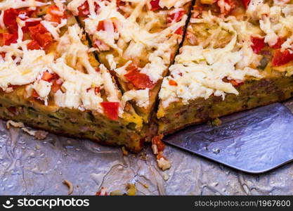 Slices of freshly baked pie with eggs, meat, vegetables and cheese. Close up photo