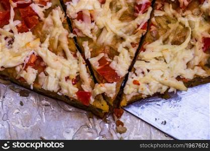 Slices of freshly baked pie with eggs, meat, vegetables and cheese. Close up photo