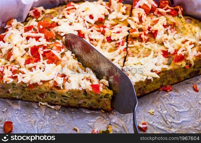 Slices of freshly baked pie with eggs, meat, vegetables and cheese. Close up photo