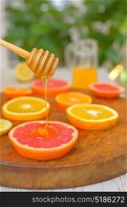 Slices of grapefruit, clementine, orange and honey
