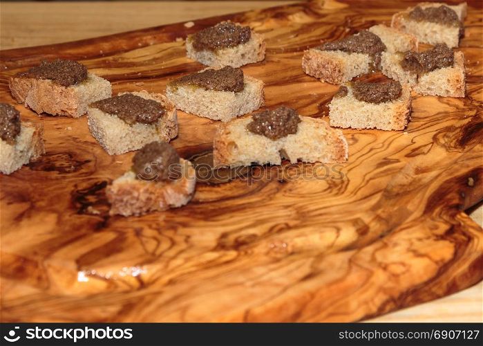 Slices of Grilled Bread with Meat Sauce on Wooden Board, Italian Snack