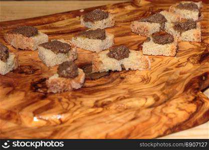 Slices of Grilled Bread with Meat Sauce on Wooden Board, Italian Snack