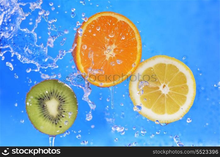 slices of kiwi, orange and lemon in water with bubbles&#xA;