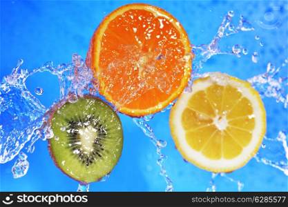 slices of kiwi, orange and lemon in water with bubbles&#xA;