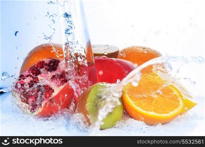 slices of kiwi, orange, pomegranate and lemon in water