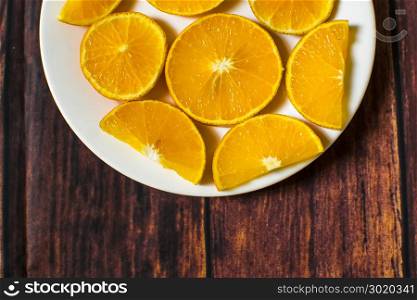 Slices of orange on wood background. top view