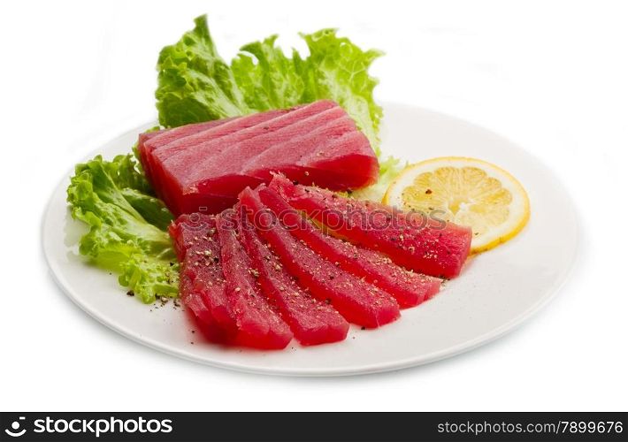 Slices of raw bluefin tuna sashimi on white dish