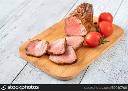 Slices of roast beef on the wooden board