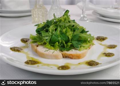Slices of roasted chicken with lettuce mixes