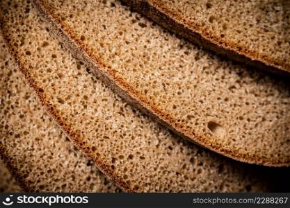 Slices of rye bread. Macro background. The texture of the bread. High quality photo. Slices of rye bread. Macro background.