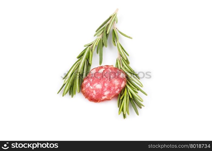 slices of salami isolated on a white background with rosemary