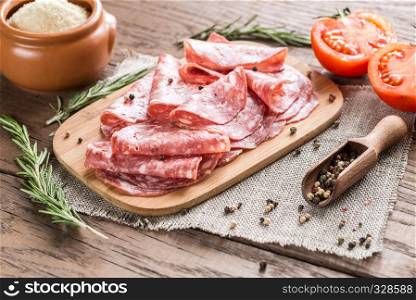 Slices of salami on the wooden board