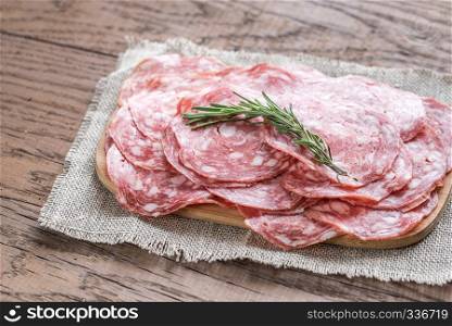 Slices of salami on the wooden board