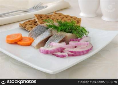Slices of salted herring fillet with onion