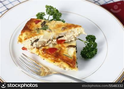 Slices of Spanish omelette on a plate with a fork.