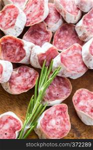Slices of spanish salami on the wooden board