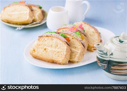 Slices of sponge cake with buttercream on plate served for tea, selective focus