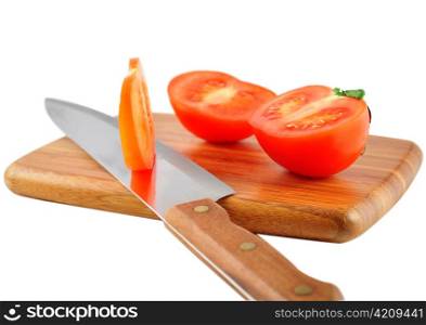 slices of tomatoes with knife on a cutting board
