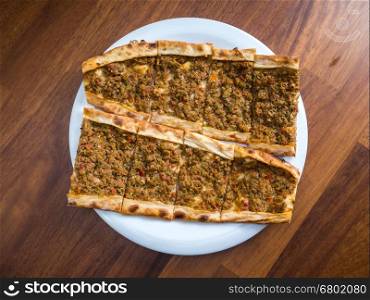 slices of traditional Turkish beef Pide on white plate