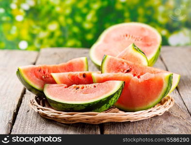 slices of watermelon on wooden table