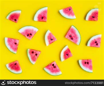 Slices of watermelon on yellow background. Top view