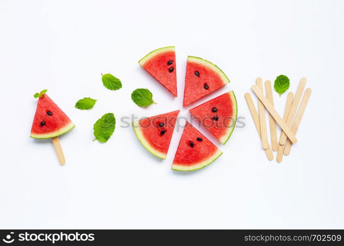 Slices of watermelon with popsicle on white background. Top view