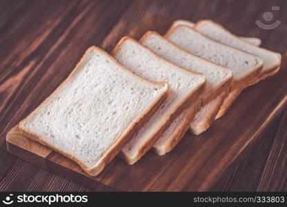 Slices of white bread on the wooden board