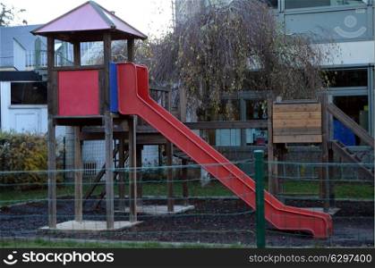 Slide of red color for children in a park