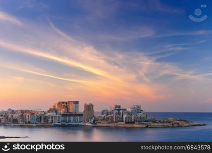 Sliema Skyline at sunset view from Valletta, Malta. Sliema, major residential and commercial area and a centre for shopping, dining, and cafe life in Malta. Skyline in the Strand and Tigne Point at sunset as seen from Valletta