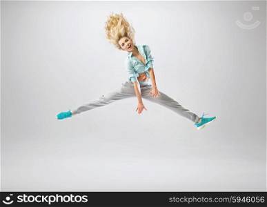 Slim and fit girl jumping high