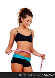 Slim brunette girl with tape measure and fitness clothes isolated on a white background