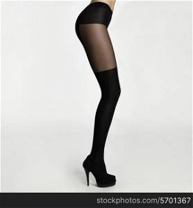 Slim female legs in stockings. Conceptual fashion art photo