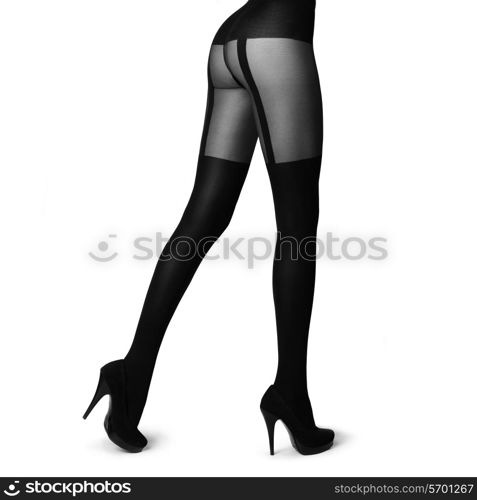 Slim female legs in stockings isolated on white. Conceptual fashion art photo