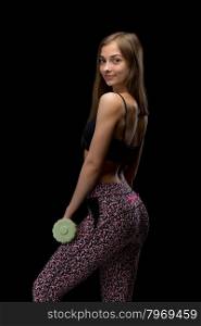 Slim fitness girl with dumbbells. Isolate in studio on a black background.