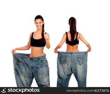 Slim girl with big jeans trousers isolated on a white background