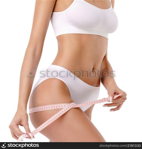 Slim long woman&rsquo;s legs isolated on white background - waist measurement. Slim tanned woman&rsquo;s body over gray background - waist measurement